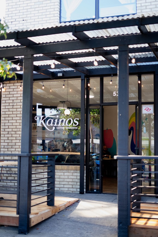 coffee shop storefront with large windows and brick facade