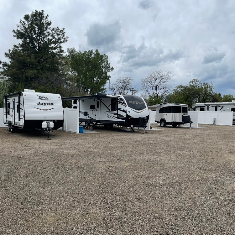 RV trailers parked at RV Park under cloudy sky