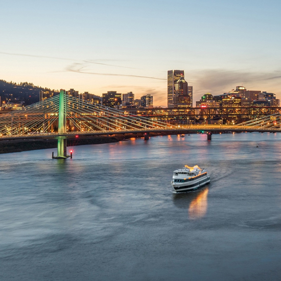 boat on river with bridge and Portland skyline in background