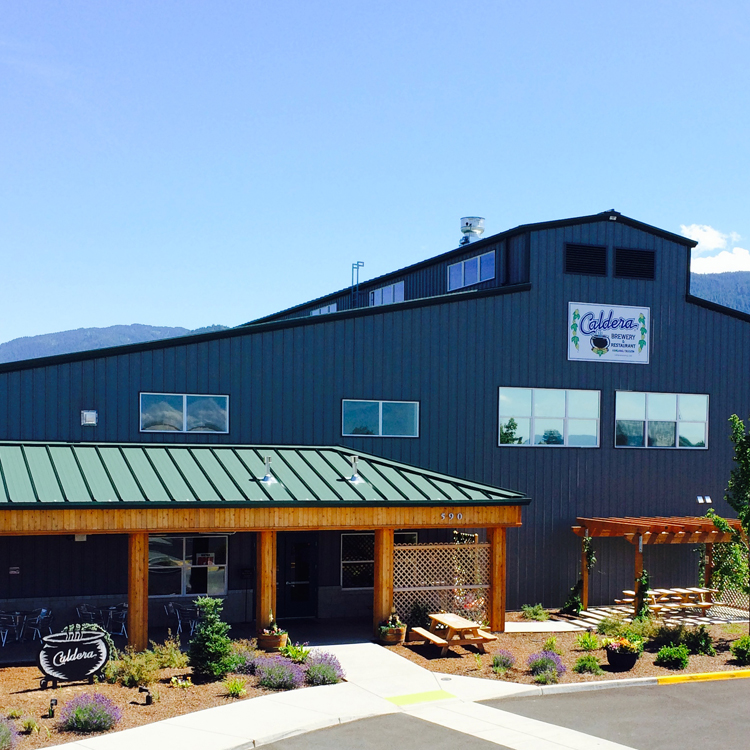 exterior of multi story building with sign for Caldera Brewing Company