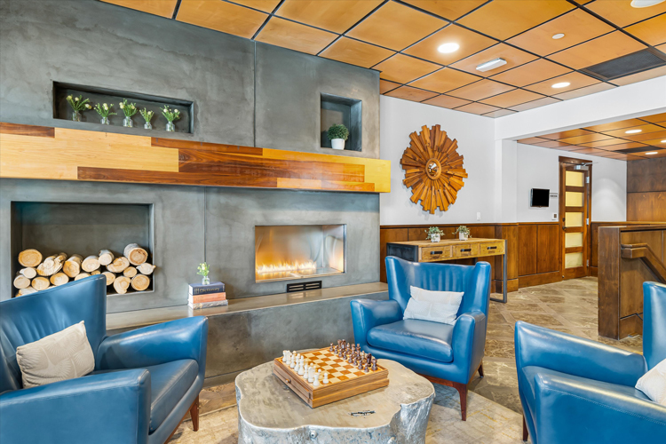 room with fireplace and blue leather chairs