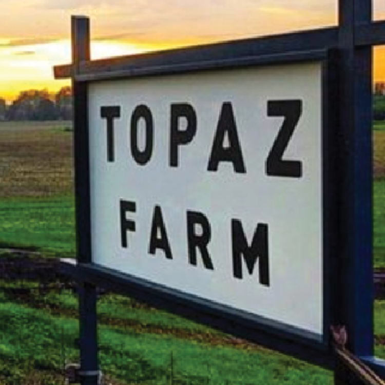 close up of sign for Topaz Farm