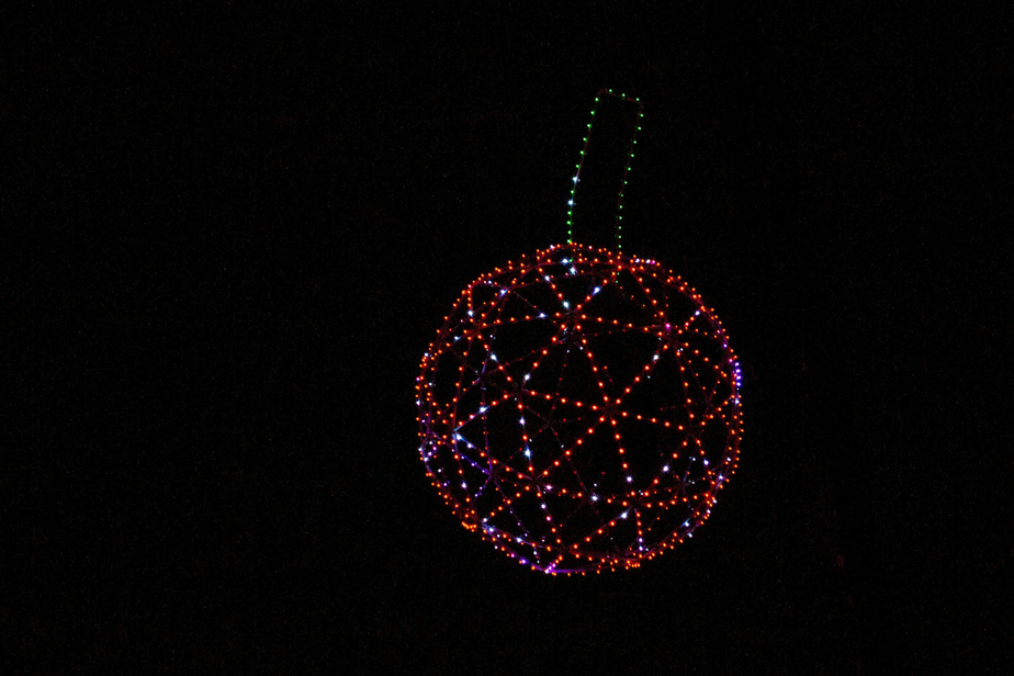 giant cherry sculpture covered in lights