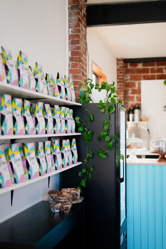 three shelves of packaged coffee beans
