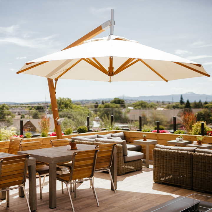 rooftop patio with seating and umbrella and panoramic view