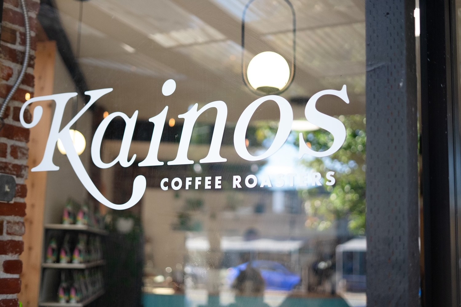 close up of window with lettering for Kainos Coffee Roasters