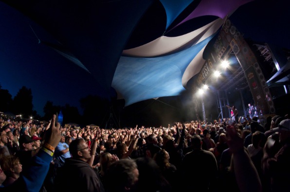 Outdoor concert with large audience.