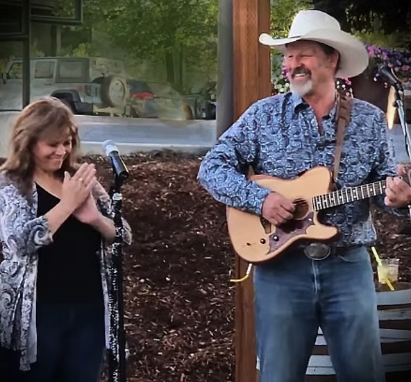 musicians Cynthia West and Kurt Silva perform on an outdoor stage