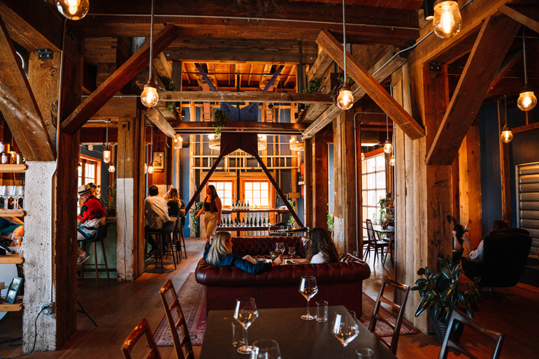 multiple small groups gathered in a winery tasting room