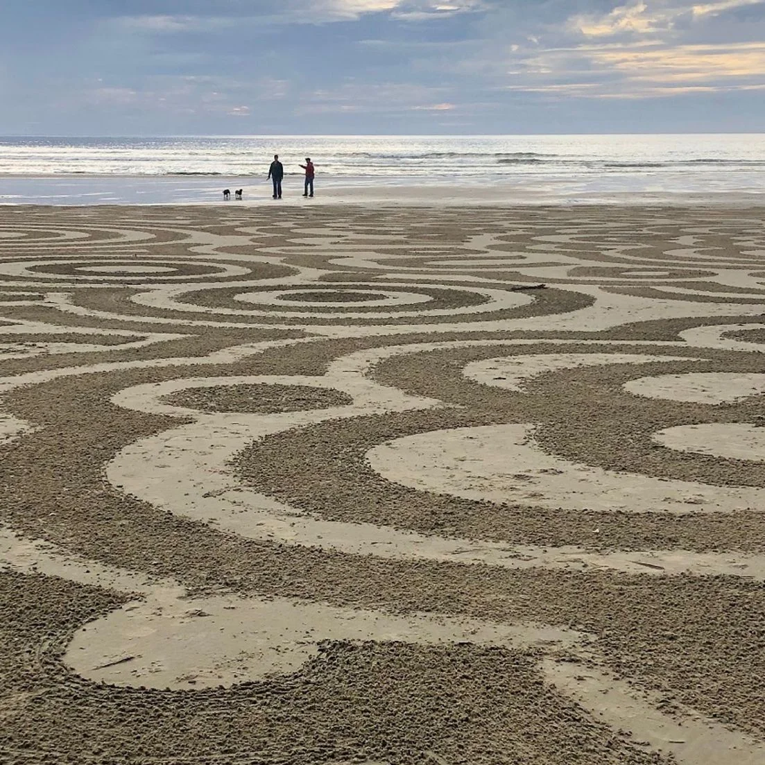 Labyrinth design in the sand of a beach.
