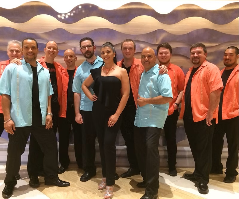 Group wearing coordinated outfits smiles at the camera.