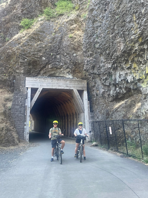 two cyclists on eBikes outside of tunnel