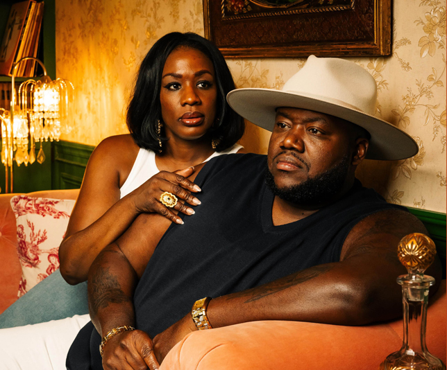 two people sit close on a couch