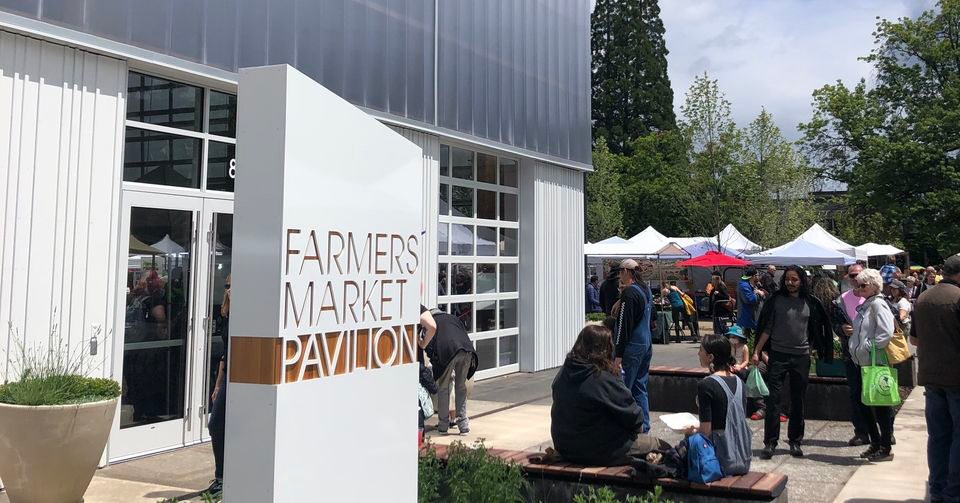 people gather outside at Farmers Market Pavilion