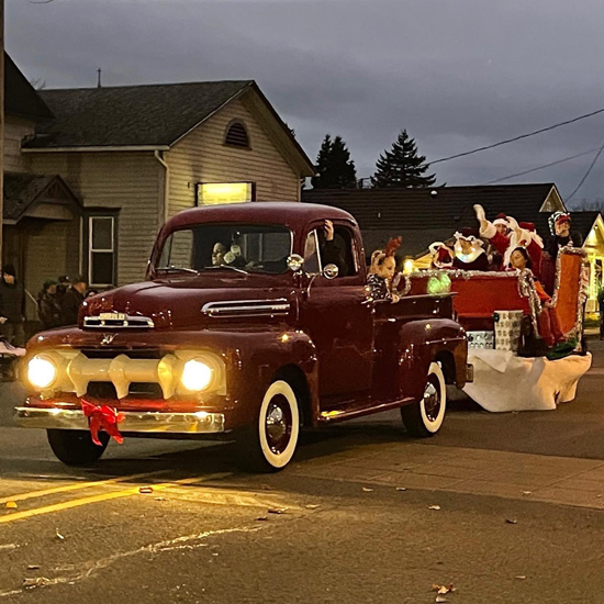 classic truck pulling parade float of santa's sleigh
