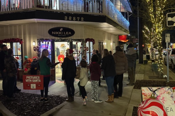 people gathered outside a boutique in the evening