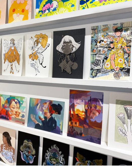 wall display of postcard sized art prints