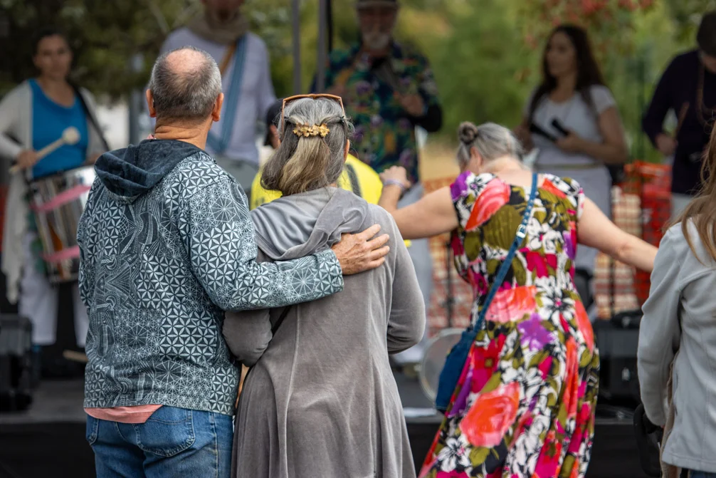 People dance to a performance at outdoor festival.