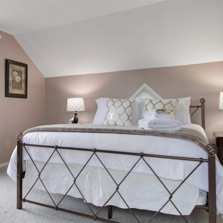 bedroom with low ceilings and windows