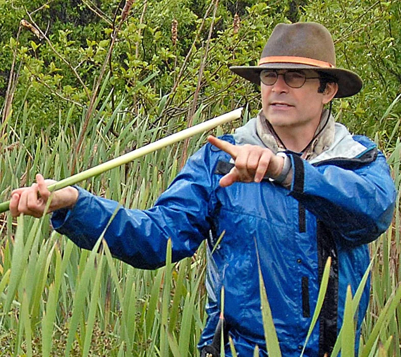 Outdoor guide points to something in the distance.