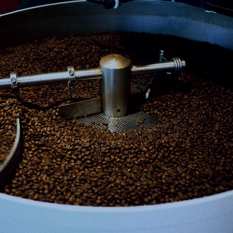 close up of coffee beans cooling on industrial cooling tray