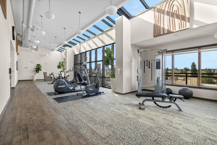 hotel fitness center with modern fixtures and large windows