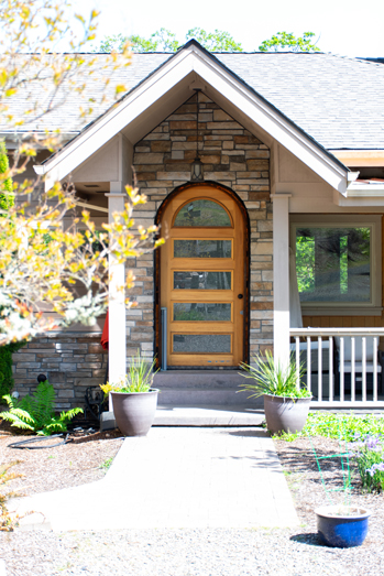 front entrance of home with bricks on facade