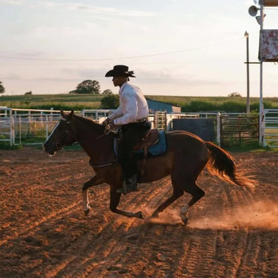 cowboy riding horse outdoors