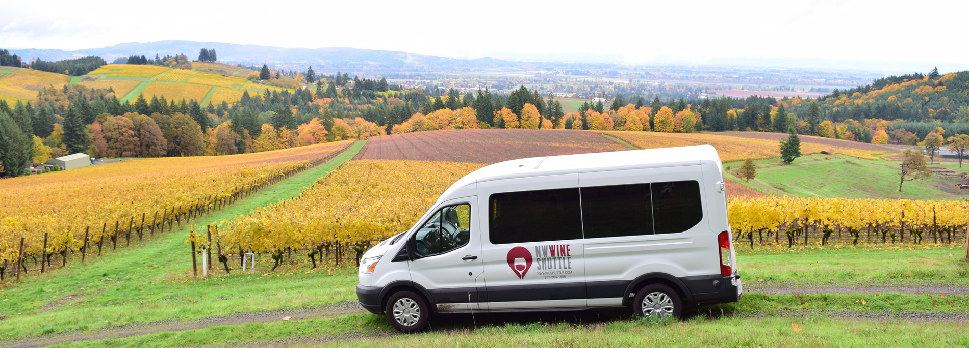 touring van with lettering for NW Wine Shuttle tour company with vineyards in background