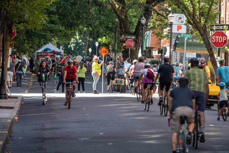 bicyclists ride through an urban area