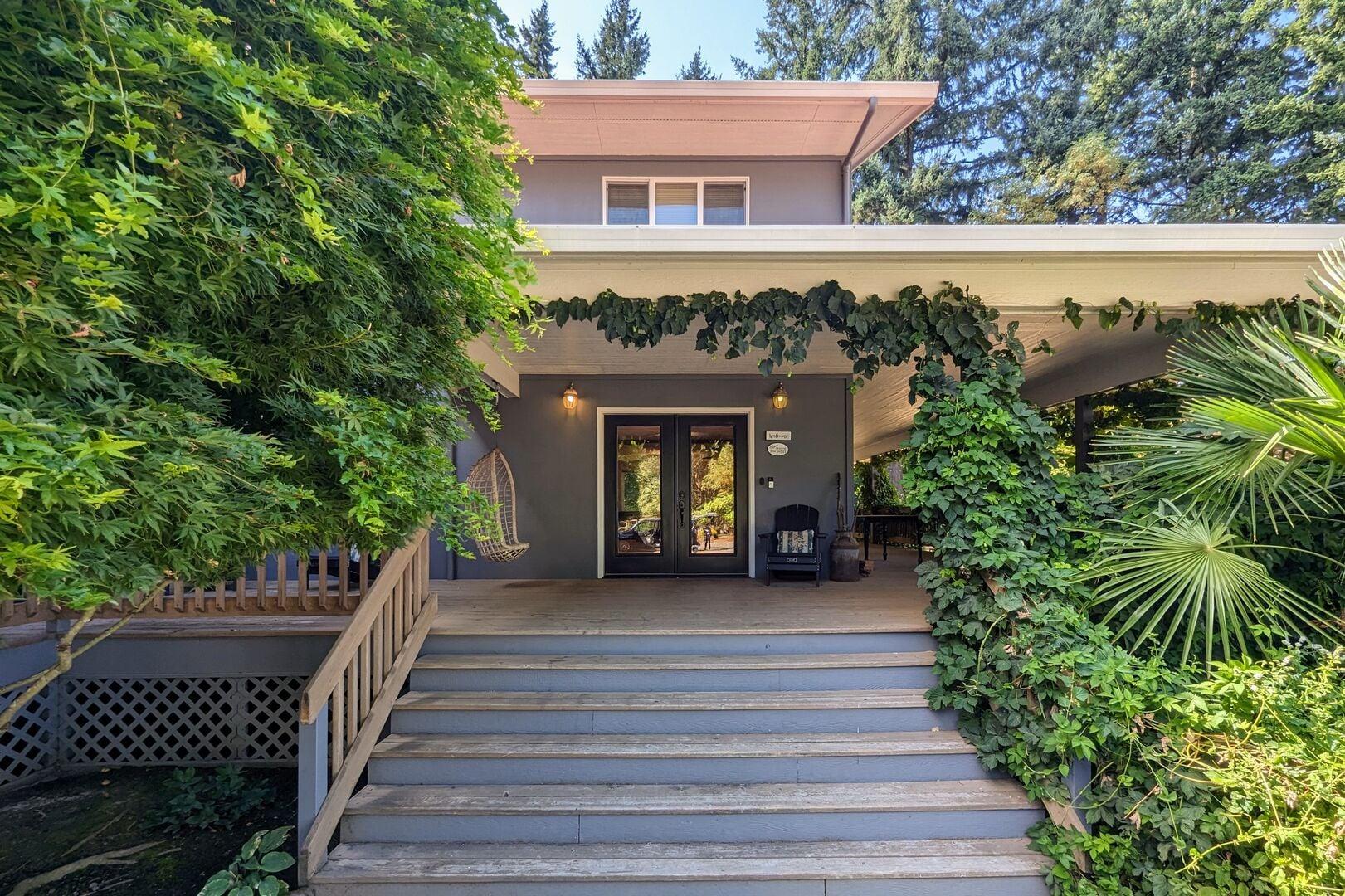 Two story home with wide steps up to front porch.