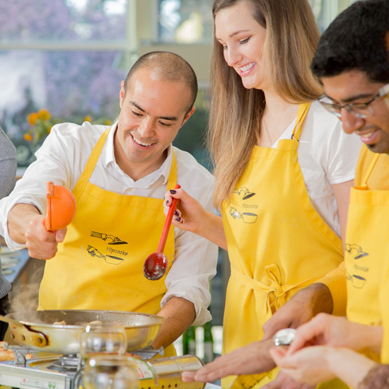 three people cook in a class