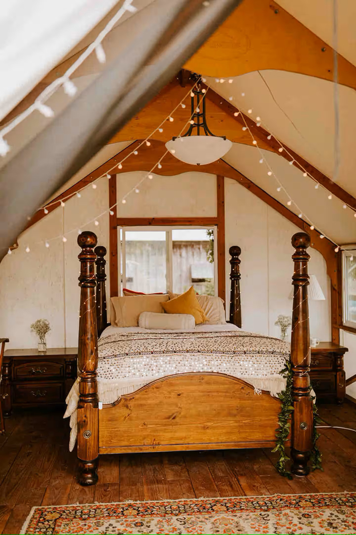 vintage four poster bed in glamping tent