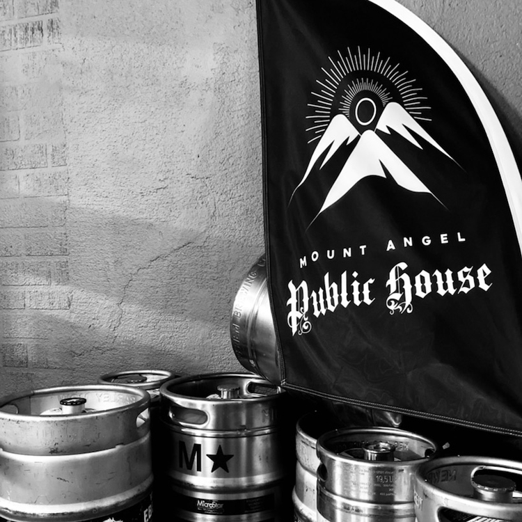 black and white image beer kegs with flag of Mount Angel Public House name and logo