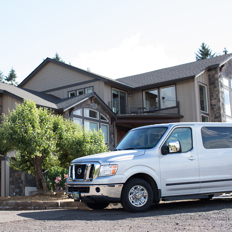large passenger vehicle parked in driveway of winery