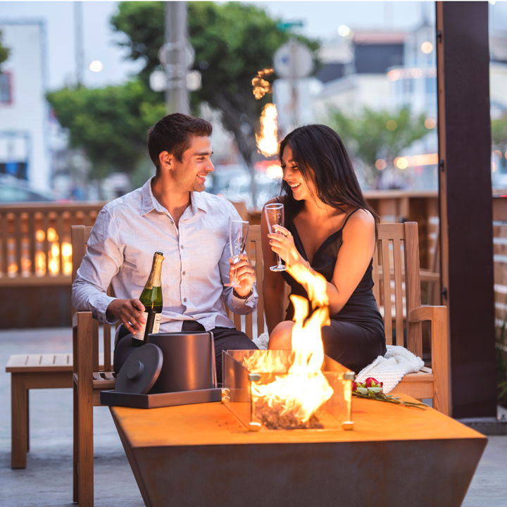 couple on outdoor patio drinking champagne by modern fire pit