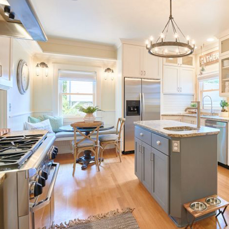 large kitchen with high ceilings, stainless steel appliances, hardwood floors and eating area with seating