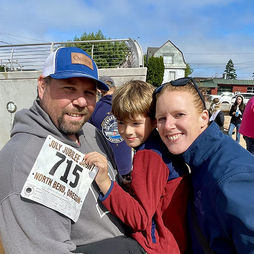 Father, mother and son outside.