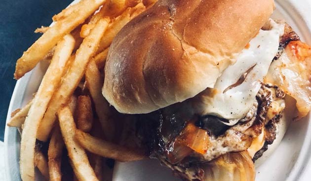 Grilled cheese burger with fries.
