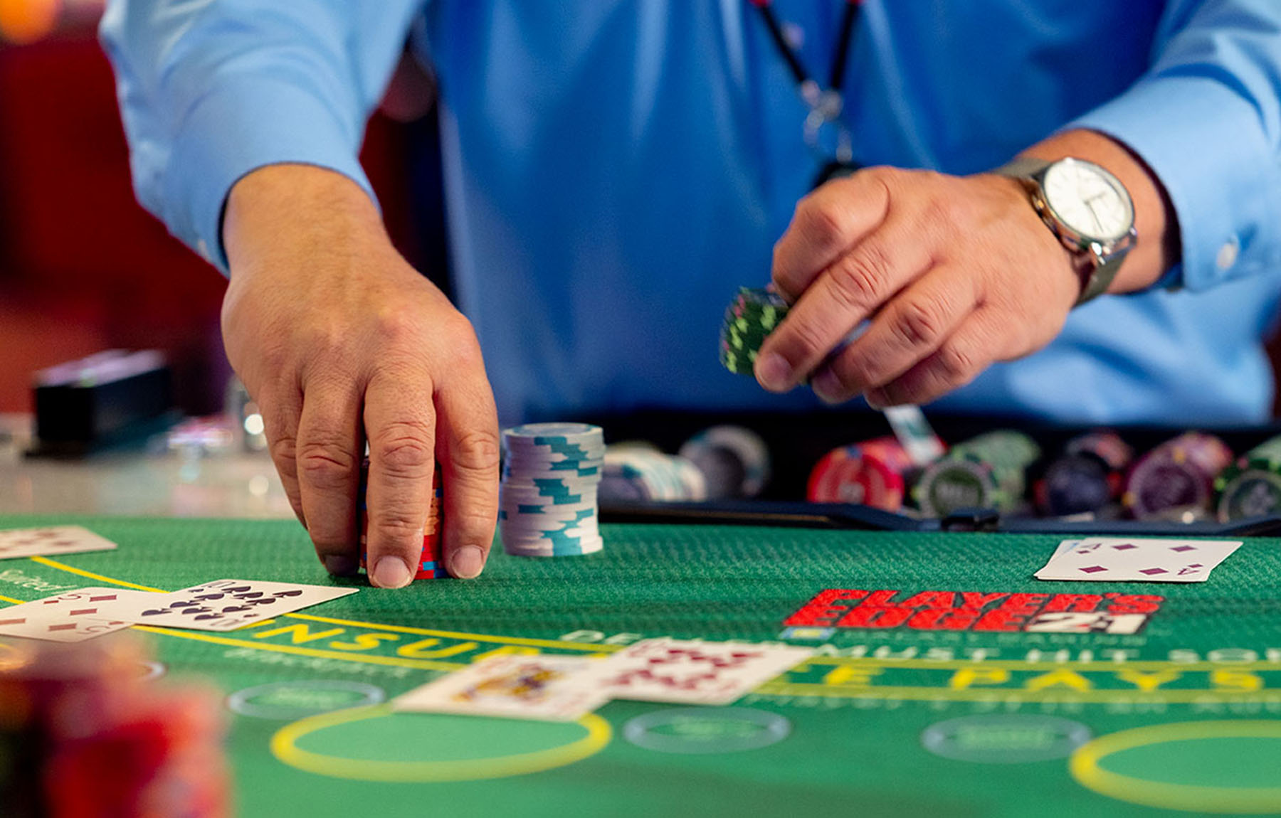Blackjack dealer handing out chips.