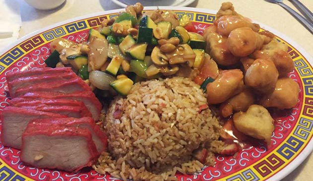 Plate with rice, pork, vegetables, and shrimp.