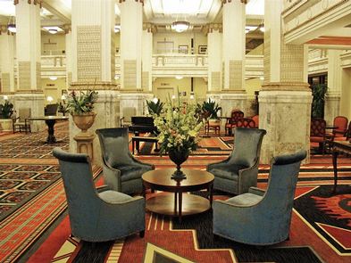 hotel lobby seating area with large stone pillars
