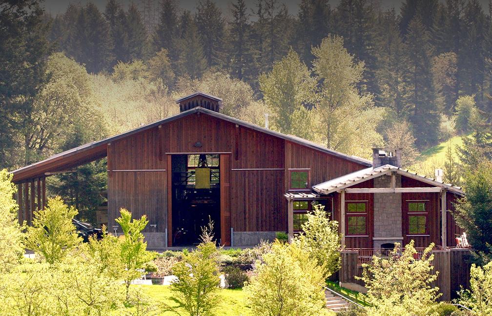 barn style tasting room among tall trees