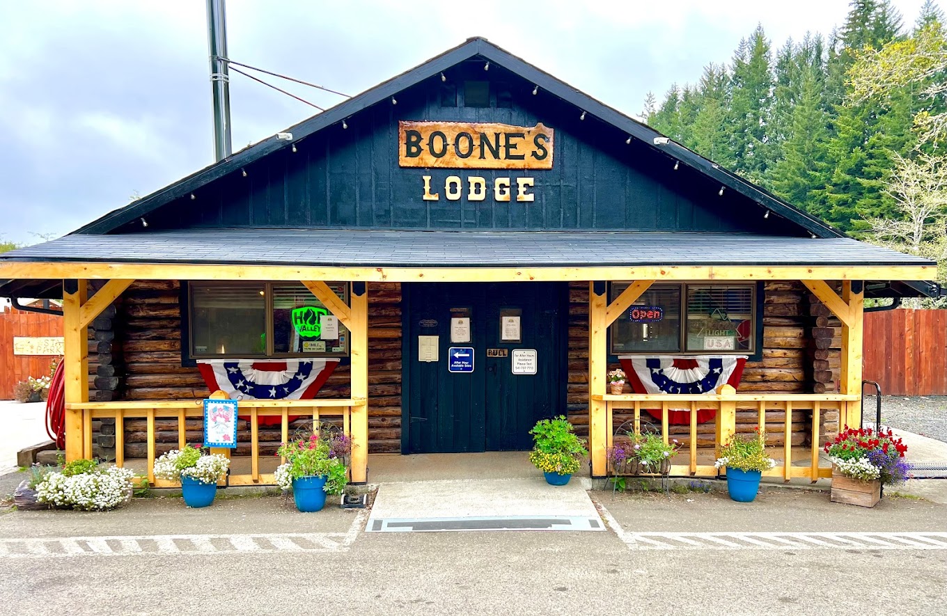 exterior of one story building with porch and sign with lettering for Boone's Lodge