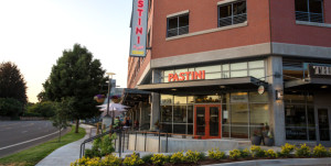 exterior of multi level building with tall glass windows on the ground floor