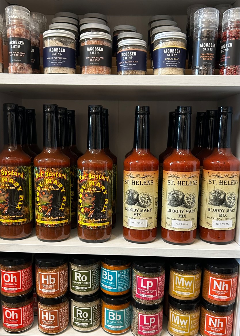 shelves with seasonings and hot sauce bottles displayed