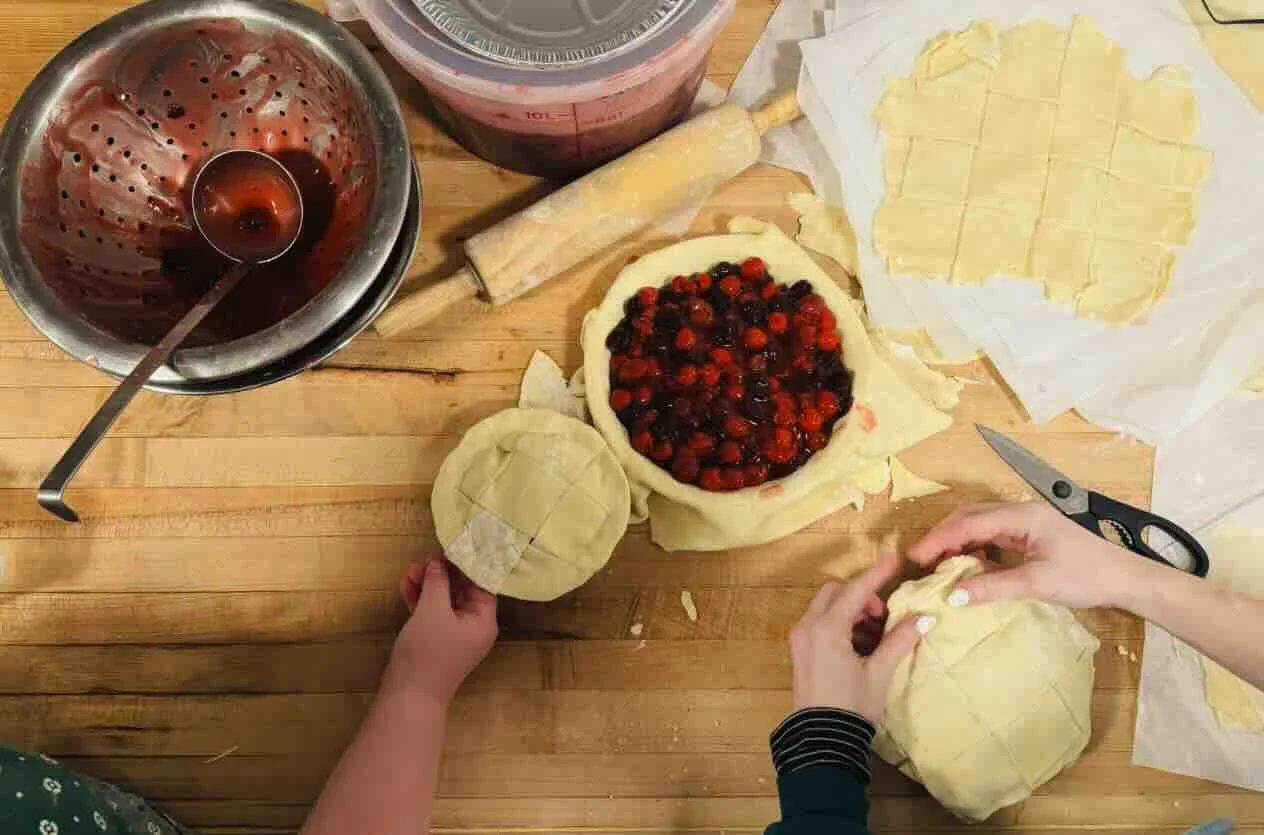 Hands making fresh pies