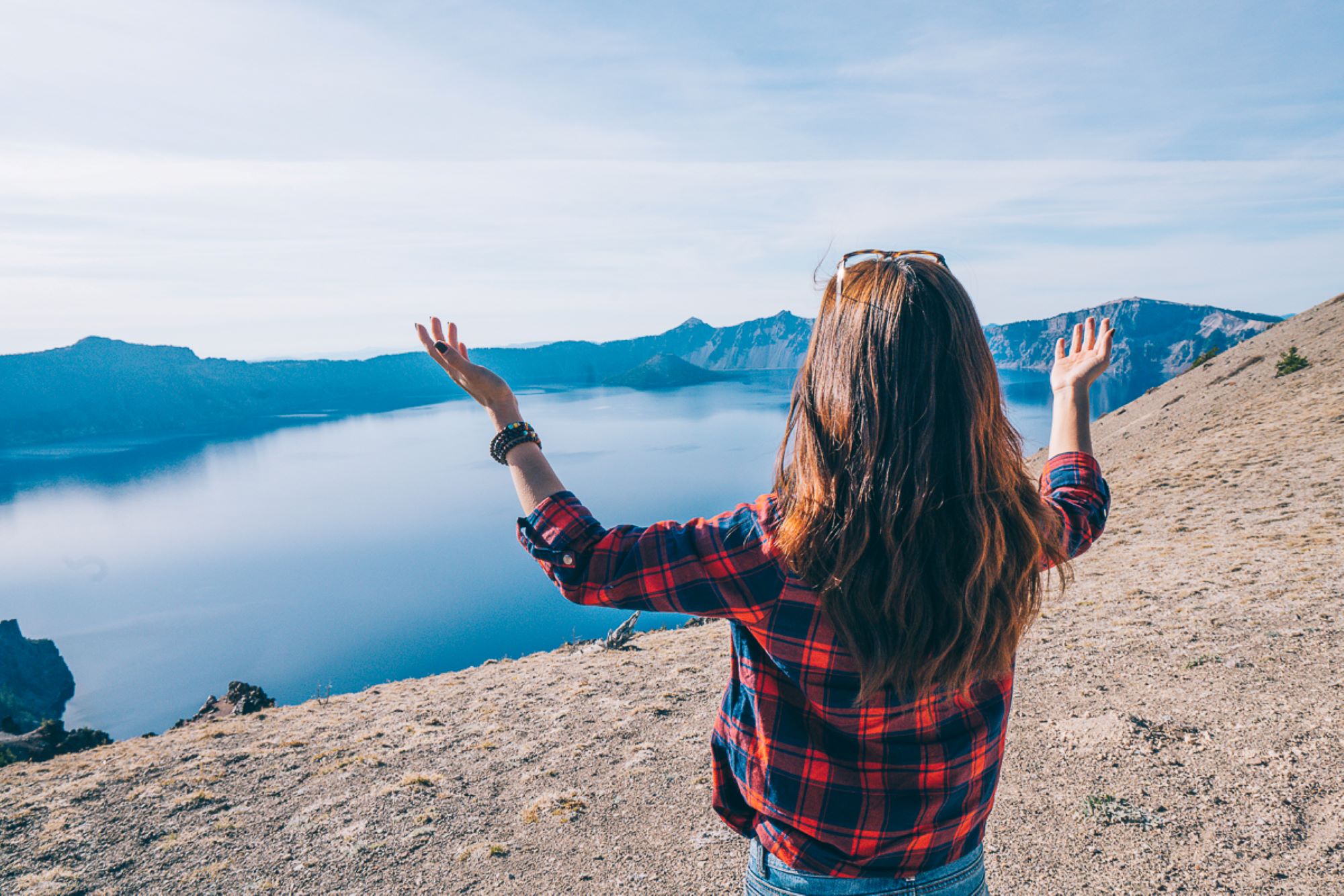 A woman is in awe at the blue waters of Crater Lake