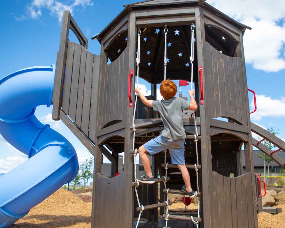 Boy climbing a play structure