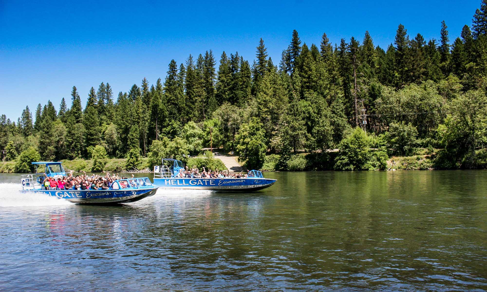 People touring the Rogue River on a jet boat